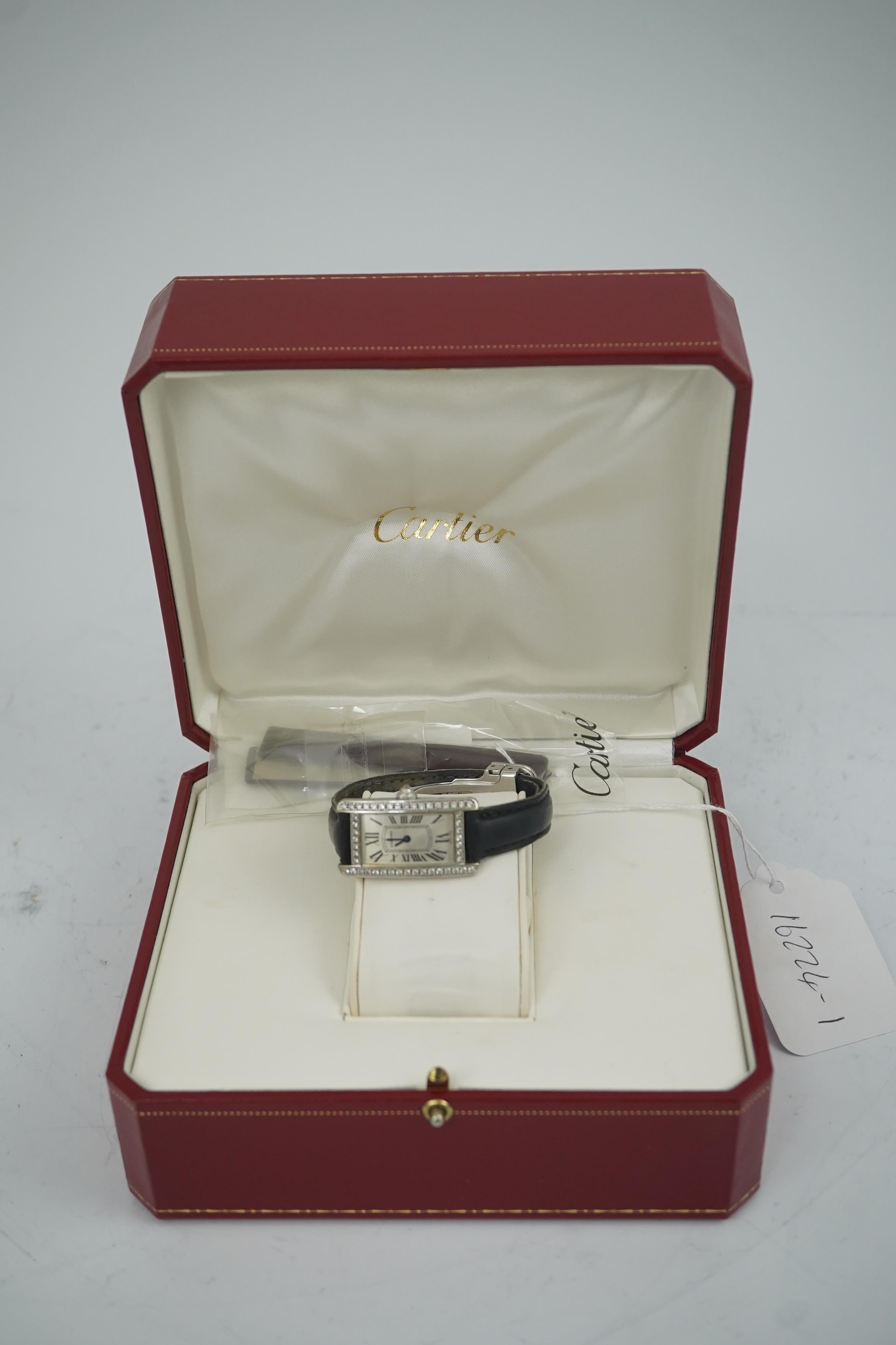 A lady's modern 18ct white gold and diamond set Cartier Tank Americaine quartz wrist watch